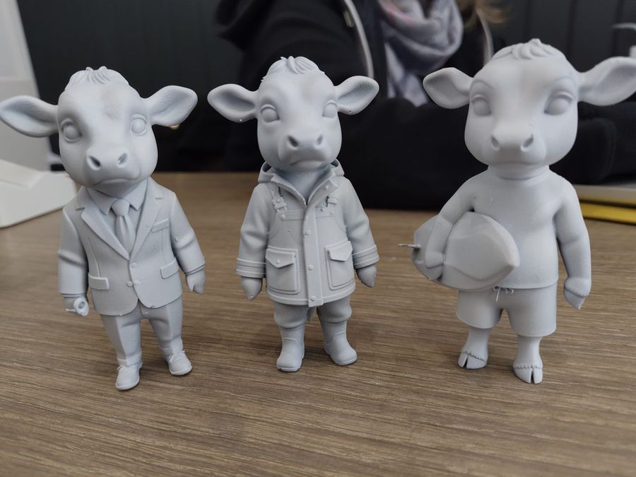 Three Physibles Herd cow figures in grey resin