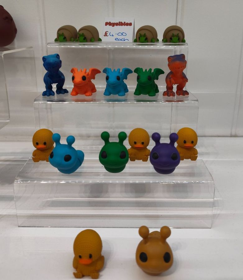 Colourful Knitted Pals figures on an acrylic stand