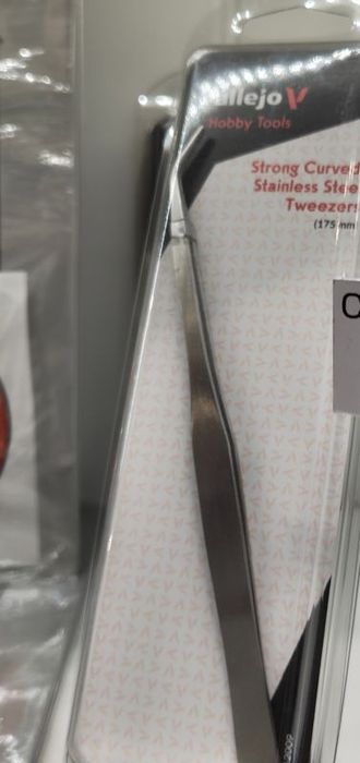 Curved stainless steel tweezers in their packet